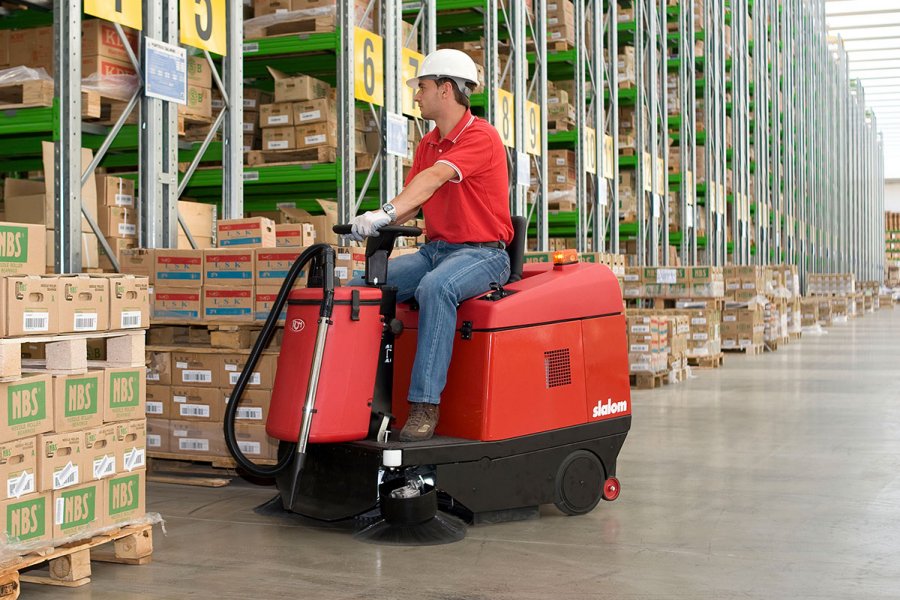 warehouse cleaning - red ride on sweeper