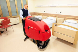 Operator using one of the latest floor scrubber-dryer machine models in the UK 2026.