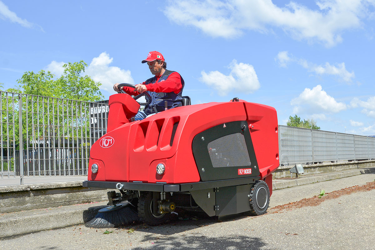 Ride-on industrial sweeper supporting energy-efficient facility cleaning operations