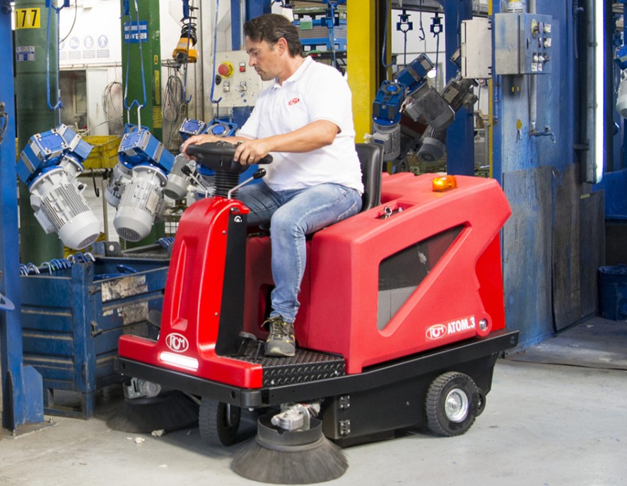 RCM Atom.3 ride-on floor sweeper cleaning a manufacturing facility
